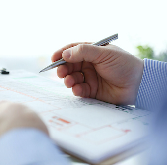 Person holding a pen and a form