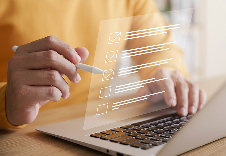 person using laptop with check marks overlayed
