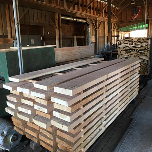 Lumber harvested from CT State Forests, milled at the Portland Complex, and used for State Park picnic benches. Pile of lumber in the DEEP Sawmill.