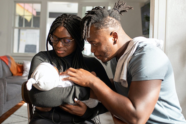 African American Couple with Newborn Baby.