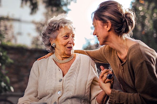 Middle age woman taking care of her parent, an elderly woman